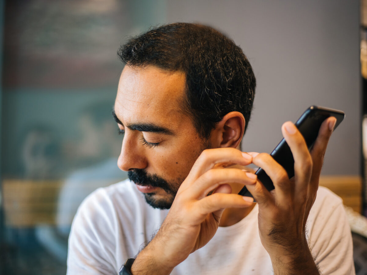 Man listening intently to phone