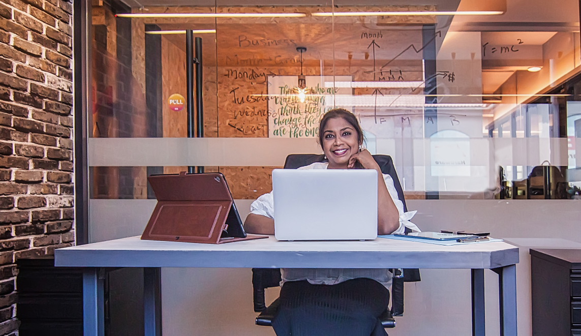 Women sitting behind laptop